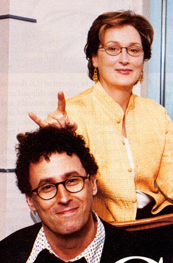 Actress Meryl Streep gives the sign of the Devil just over the head of Angels in America director, Mike Nichols.