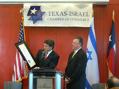 Governor Perry receives an award from the Texas-Israel Chamber of Commerce, aprivate Zionist business organizationPerryestablished in September 2007. A glance at theboard members of Perry'sgroup ofIsraeli supportersreveals the heads of two of Mossad's biggestintelligence gathering companies in the United States: Amdocs and Elbit. Elbit (a military subsidiaryof Elron)is directlyinvolved in stealing presidential elections in the United States through its control of the tally of the Iowa caucus.